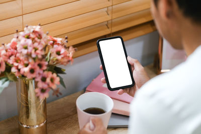 Midsection of woman using mobile phone