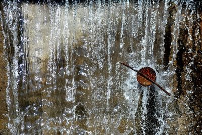 Waterfall splashing on rusty metal