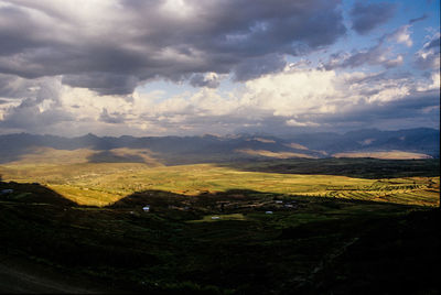 Scenic view of landscape against cloudy sky