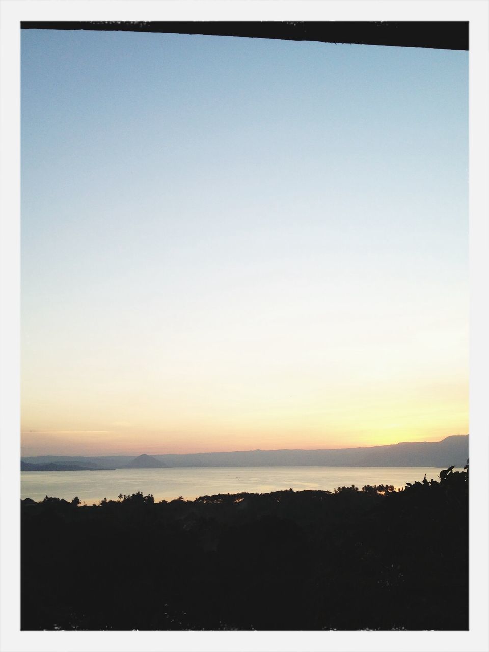 sea, transfer print, horizon over water, clear sky, water, scenics, copy space, sunset, tranquil scene, beauty in nature, tranquility, auto post production filter, nature, idyllic, beach, silhouette, blue, sun, orange color, shore