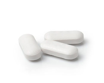 Close-up of pills on white background