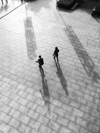 Directly above shot of man and woman walking on pathway