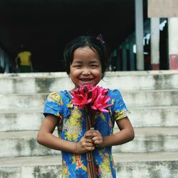 Happy girl holding flower