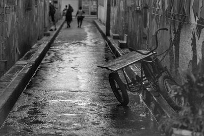Tricycle on alley amidst buildings in city