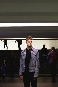 Full length of a young man walking in an underground passage