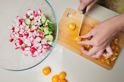 Cooking - chef's hands preparing a vegetable vegetarian dish. kitchen landscape - glass bowl with