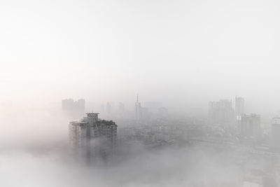 Aerial view of modern buildings in city against sky