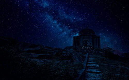 Low angle view of illuminated building against sky at night