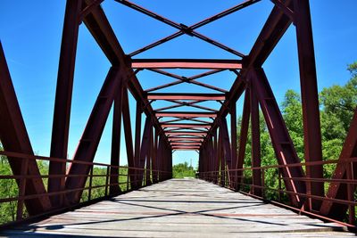 Footbridge against blue sky