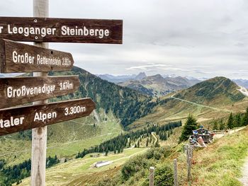 Information sign on landscape against sky