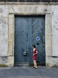 Full length of woman standing outside building