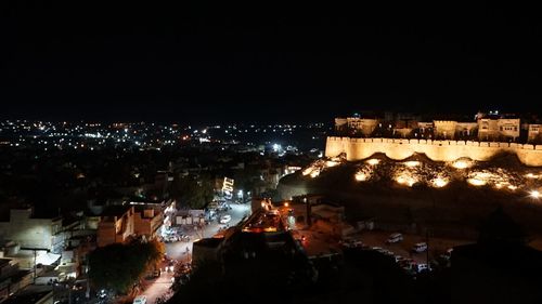 High angle view of illuminated city buildings at night