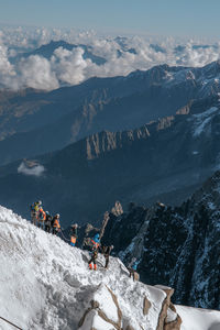 High angle view of people hiking on snowcapped mountain