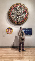 Full length of man standing against wall