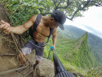 Rear view of man working on mountain