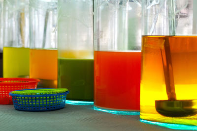 Close-up of multi colored glass on table