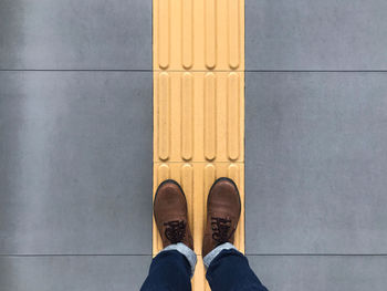 Low section of man standing on floor