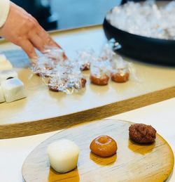 Close-up of person preparing food on cutting board