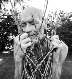 Portrait of man holding plant