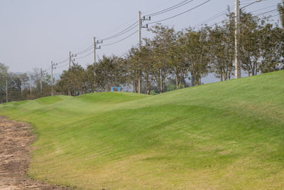 Scenic view of golf course against sky