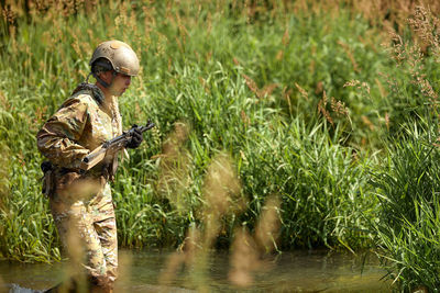 Rear view of woman standing on field