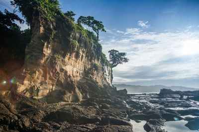 Rocky coast against sky