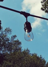 Low angle view of light bulb against sky