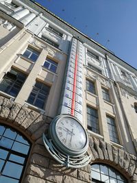 Low angle view of historic building with temperature thermomete against sky
