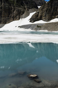 Scenic view of lake against mountain during winter