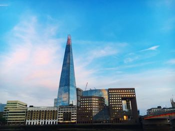 Low angle view of buildings against cloudy sky