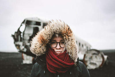 Adventurous portrait of young female infront of famous icelandic wreck