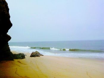 Scenic view of beach against clear sky