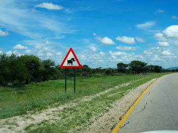 Road sign against clear sky