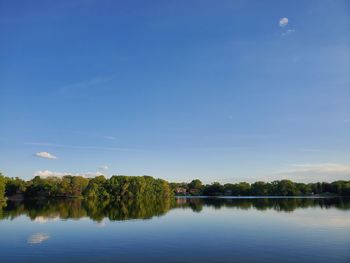 Scenic view of lake against blue sky