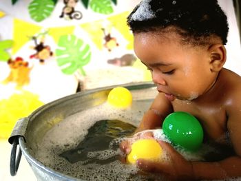 Close-up of boy playing with toys at home