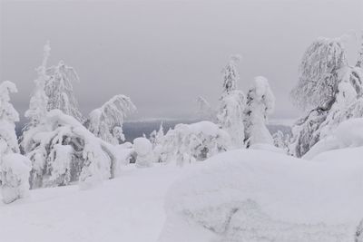 Snow covered landscape against sky