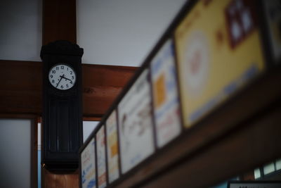 Low angle view of clock on wall