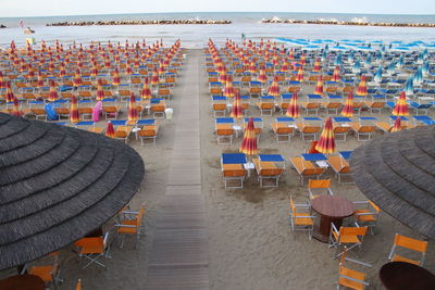 High angle view of empty chairs at beach