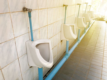 Men's room urinals discharge ,toilet bowl in a modern bathroom,flush toilet clean bathroom
