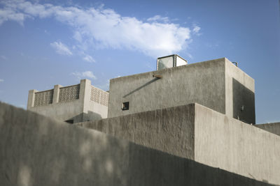 Low angle view of building against cloudy sky