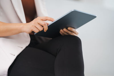 Midsection of woman using mobile phone