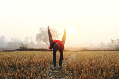 Man exercising on field