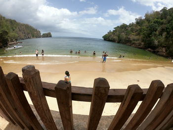 People on beach against sky