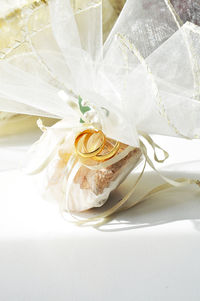 Close-up of wedding rings with decoration on table