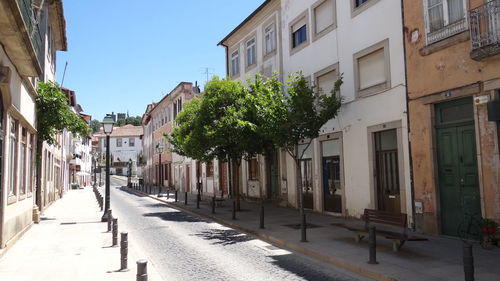 Street amidst buildings against sky