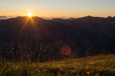 Scenic view of field against sky during sunset
