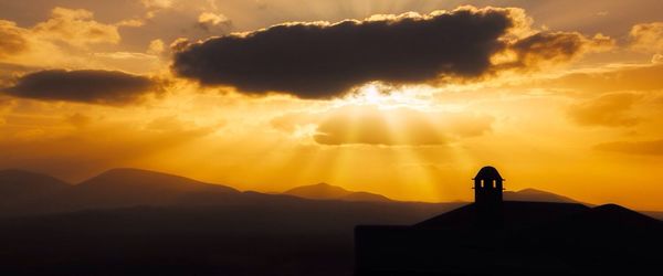 Scenic view of mountains against sky during sunset