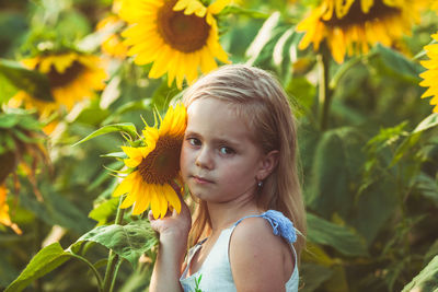 Portrait of woman with yellow flowering plants
