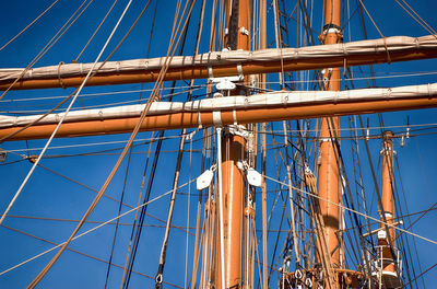 Low angle view of sailboat against blue sky