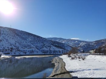 Scenic view of snowcapped mountains against clear sky